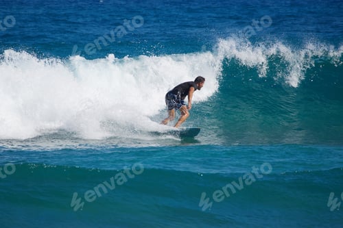 Preview: Man Riding A Wave On A Surfboard