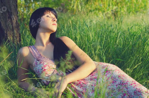 Preview: Beautiful Girl In Long Dress Lying On Meadow On Sunny Spring Day.