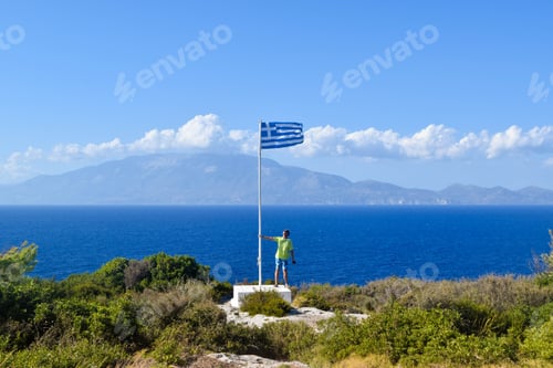 Preview: The Guy Near The Flag Of Greece At Cape Skinari, Zakynthos Island.