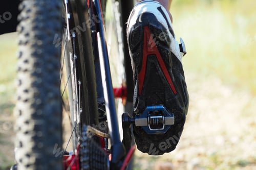Preview: Low Angle View. Detail Of Cyclist Man Feet Riding Mountain Bike On Outdoor. Trail On Country Road