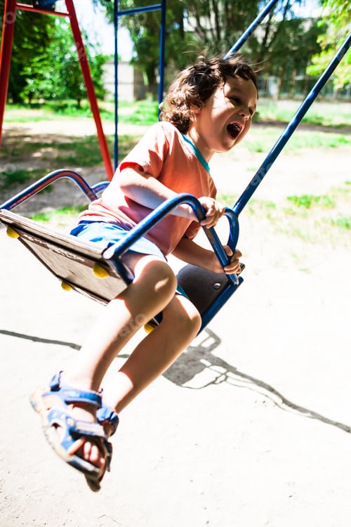 Preview: The Boy Is Riding On A Swing In The Amusement Park, A Happy Childhood.