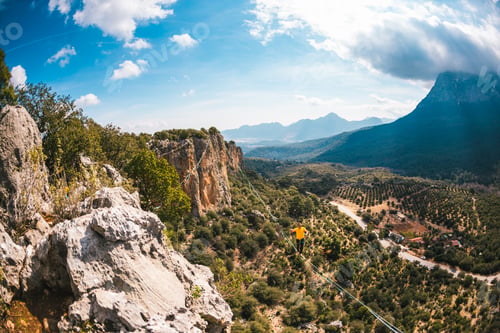 Preview: A Man Is Walking Along A Stretched Sling. Highline In The Mountains. Man Catches Balance