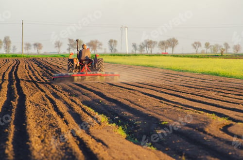 Preview: Tractor Plowing The Agricultural Field On Sunny Summer Day.