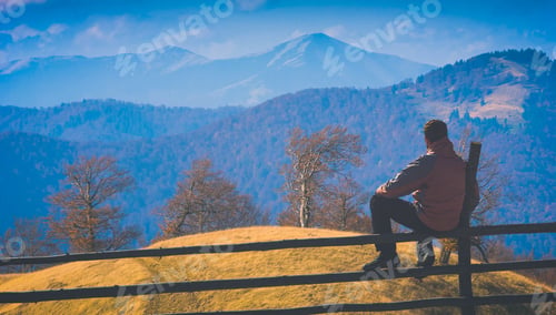 Preview: Man Sitting On A Wooden Fence And Contemplates The Carpathian Mountain Valley. Instagram