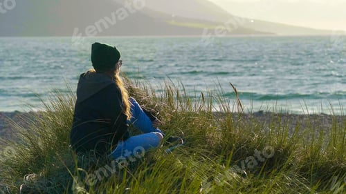Preview: Pretty Girl Sits In The Reed Grass At The Beach