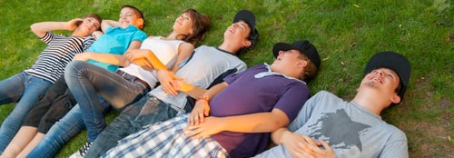 Preview: Teenage Boys And Girls Lying On The Grass On Beautiful Sunny Spring Day.