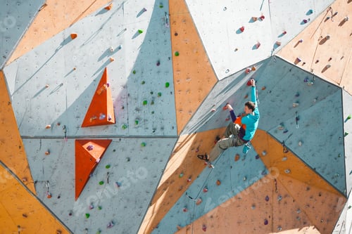 Preview: A Climber On An Artificial Relief. A Man Climbs The Climbing Wall. Training On A Street Climbing
