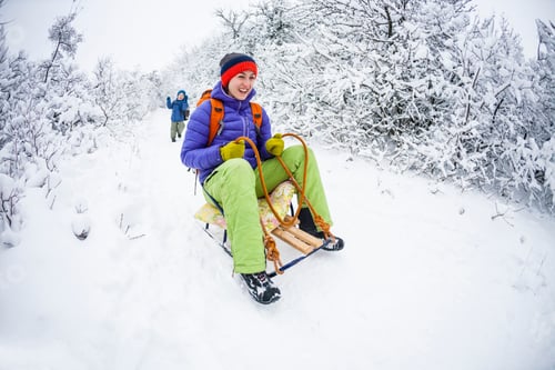 Preview: The Boy Runs Through The Snow. A Child With A Backpack Is Catching Up His Mother On A Forest Path