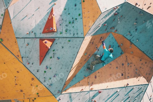Preview: The Climber Trains On An Artificial Relief. A Man Climbs A Climbing Route On A Street Climbing