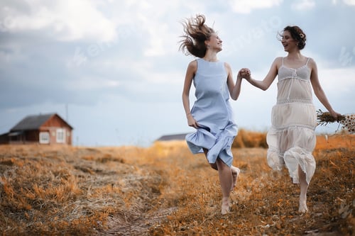Preview: Two Beautiful Girls In Dresses In Autumn Field Have Fun