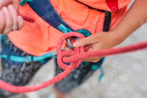 Preview: The Girl Is Learning To Knit Knots. A Climber Knits A Knot. A Woman Prepares To Climb A Climbing