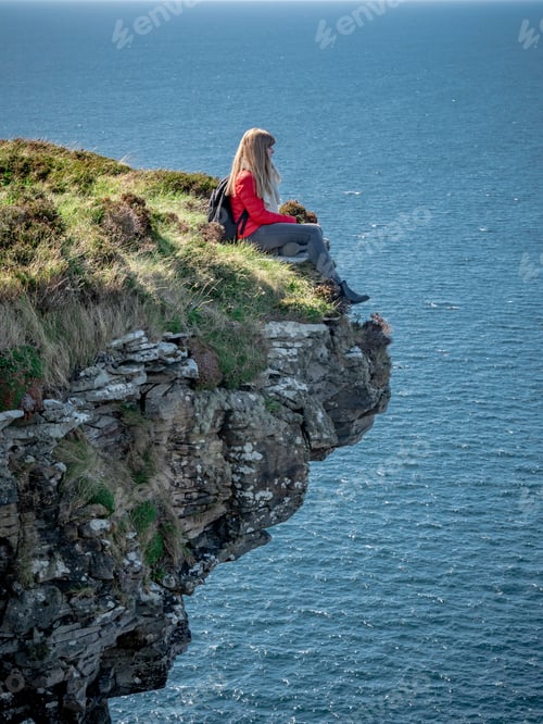 Preview: Reckless Woman Sitting On The Edge Of A Cliff At The Irish West Coast - Travel Photography