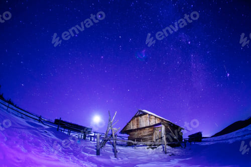 Preview: Wooden House With A Light In The Window. Night Landscape In Winter