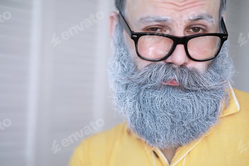 Preview: Cheerful Hipster Man With White Beard. Surprised Man With Glasses Looks In Front.