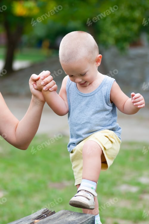 Preview: Little Happy Boy Climbing Up The Wooden Pillar On The Outdoor Playground In Summer.