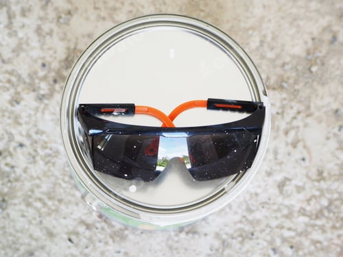 Preview: Closeup Of Dirty Safety Glasses On A Can With White Paint.