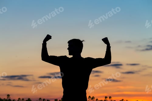 Preview: Silhouette Of Male Celebrating With Arm Up Towards The Sunrise