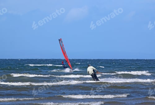 Preview: Kitesurfer And Windsurfer On The Sea