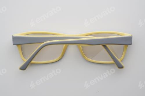 Preview: Eyeglasses With Gray And Yellow Color Frame On White.