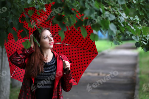 Preview: Woman In A Raincoat And An Umbrella
