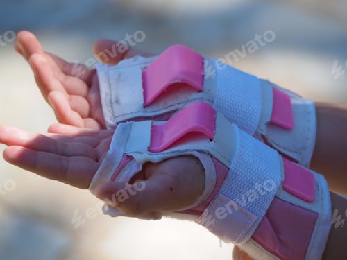 Preview: Little Girl Puts On Protection For Roller Skating. Close Up.