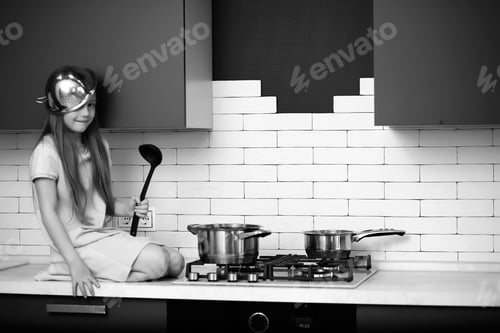 Preview: Little Girl In The Kitchen With Cooking Equipment