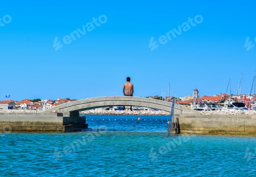 Preview: The Guy On The Bridge On The Background Of Vodice Cityscape, Croatia.