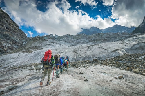 Preview: Group Of Hikers With Backpacks Climb The Glacier To The Peak Of Mountain. Caucasian Mountains
