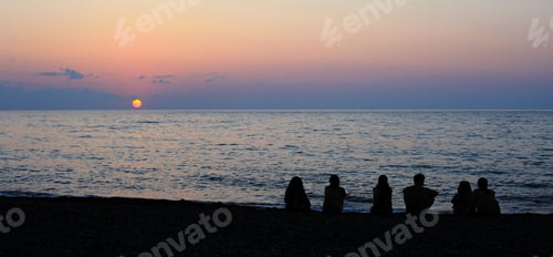 Preview: Silhouettes Of Young Group Of People On The Sunset Near The Sea