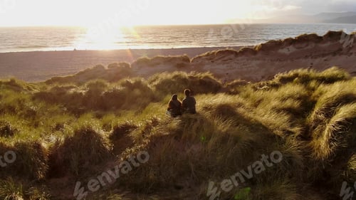 Preview: Young Couple Enjoy The Sunset Over The Ocean – Aerial Drone Footage