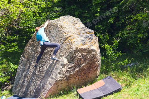 Preview: Climber Is Bouldering In Nature. Girl Climbs On A Big Stone. Woman Doing Sports Outdoors. Athlete