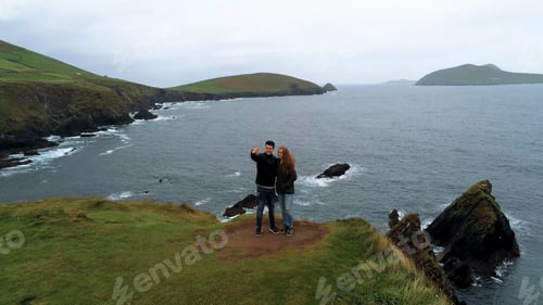 Preview: Young Couple Takes A Selfie At Dunquin Pier – Ireland Aerial Flight Footage