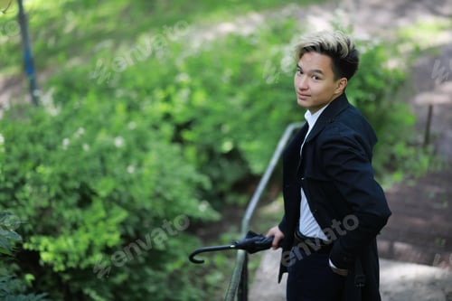 Preview: Spring Park In Rainy Weather And A Young Man With An Umbrella