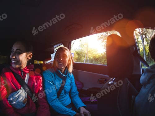 Preview: Two Women In The Back Seat Of A Car. Girlfriends Are Hitchhiking. Passengers During A Long Trip