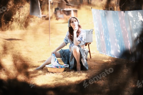 Preview: Pregnant Woman Hanging Sheets On The Rope For Drying