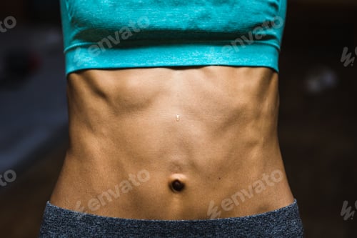 Preview: The Belly Of A Slim Woman Close Up. Female Press. A Drop Of Sweat On A Thin Sports Stomach. Bulging