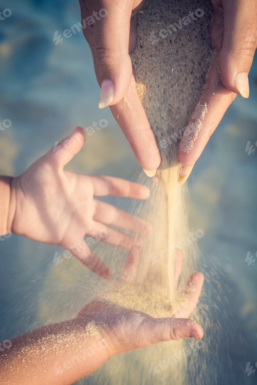 Preview: Mother And Small Baby Play With Sand. Mom Throws Sand To The Baby Arms.
