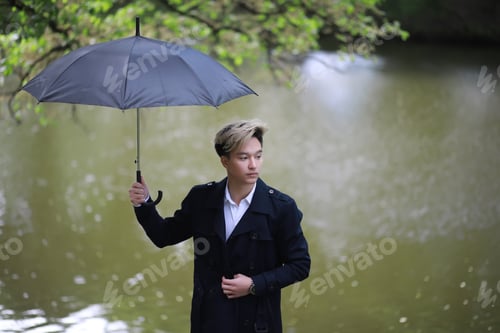 Preview: Spring Rainy Weather And A Young Man With An Umbrella