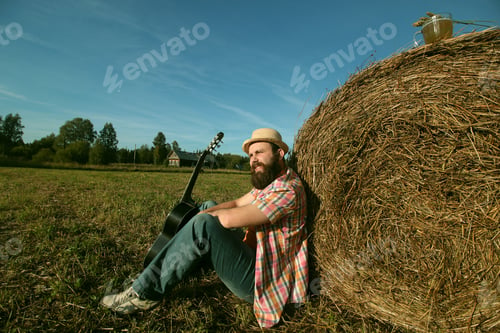 Preview: Man With Guitar And Beer On The Nature