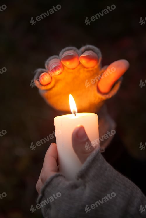 Preview: Praying Hands With Candle In Dark Background