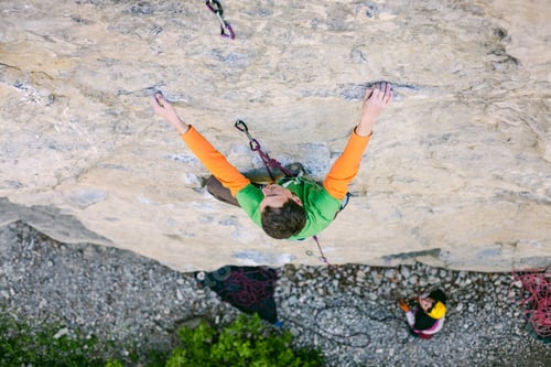 Preview: A Man Is A Rock Climber On A Rock. Friends Go In For Sports In The Open Air. Girl In Helmet Insures