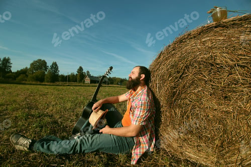 Preview: Man With Guitar And Beer On The Nature