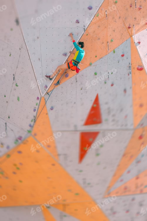 Preview: The Climber Trains On An Artificial Relief. A Woman Climbs A Climbing Route On A Street Climbing