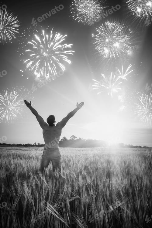 Preview: Man Who Enjoy Holiday Firework In A Wheat Field At Sunset Light. Black And White