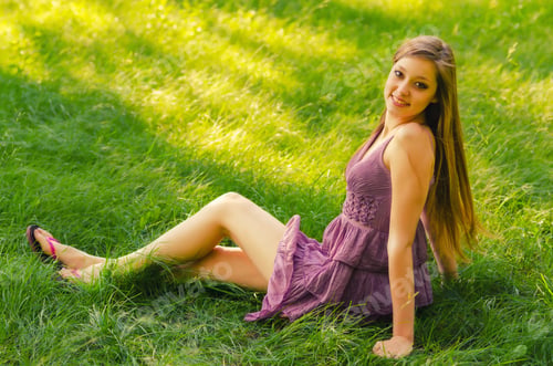 Preview: Beautiful Girl Sitting In The Grass On Sunny Summer Day.