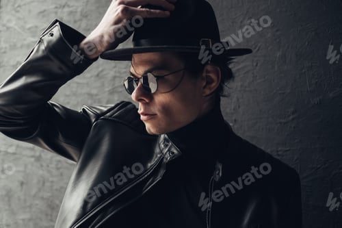 Preview: Portrait Of Stylish Young Man In Black Leather Jacket And Hat
