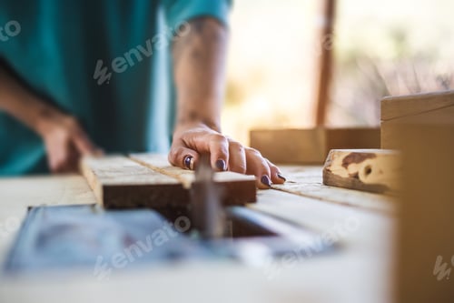 Preview: A Woman Works In A Carpentry Workshop. The Girl Handles The Wood. Woman In The Male Profession