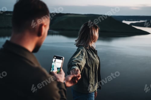 Preview: Two Young And Happy Travelers Having Good Time In Sunset Next To Canyon
