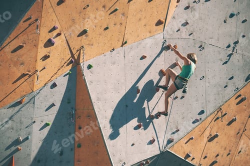 Preview: The Climber Trains On An Artificial Relief. A Woman Climbs A Climbing Route On A Street Climbing