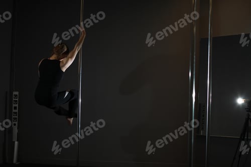 Preview: Girl Doing Exercises On A Sports Equipment. The Dancer On The Pylon In The Studio.